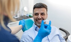 Invisalign dentist showing a patient how to use Invisalign