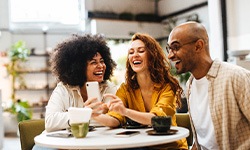 group of work friends talking and laughing together