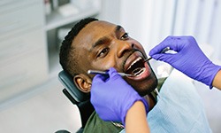 patient having his mouth examined for an Invisalign check-in
