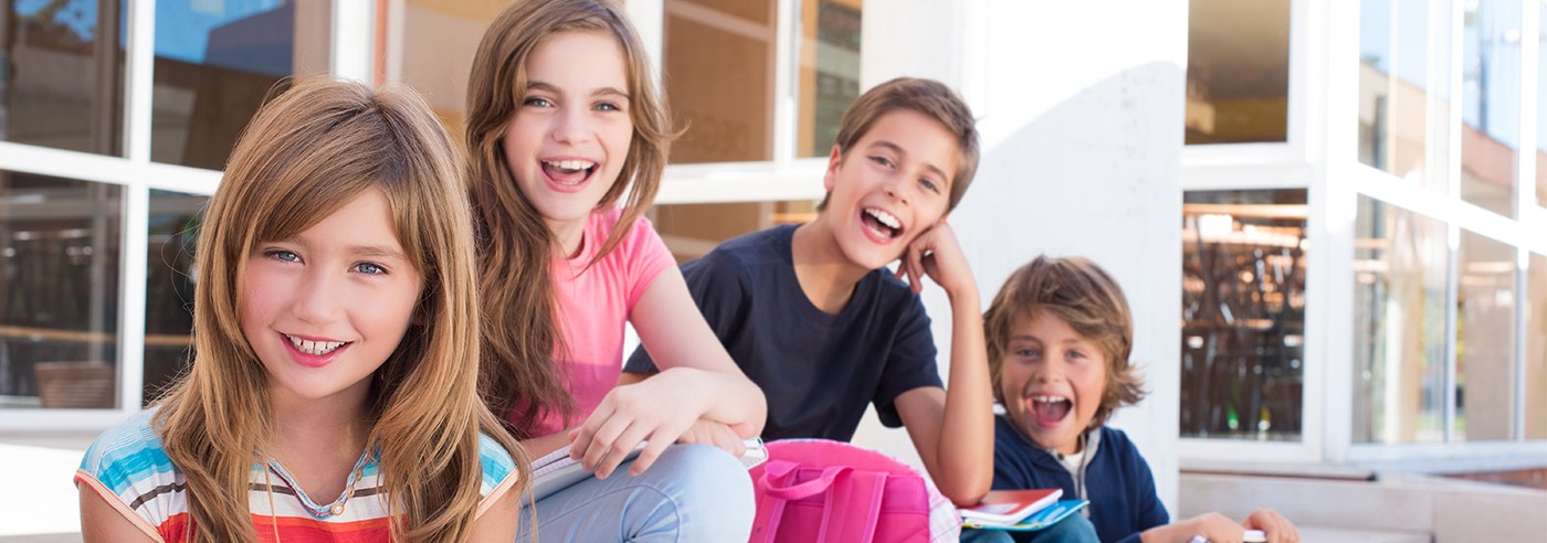 Four kids with healthy smiles after children's dentistry visit