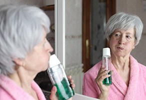 Dentures patient in West Seneca rinsing their mouth