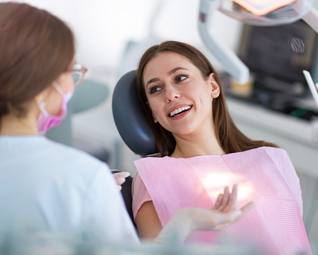 Woman smiling at dentist during dental checkup