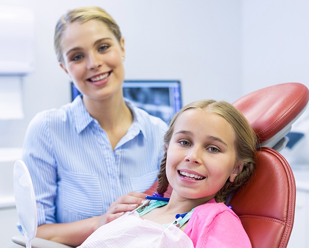 Little girl smiling during children's dental checkup