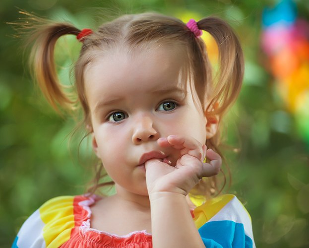 Little girl sucking her thumb