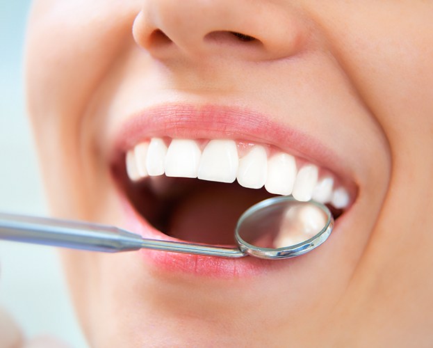 Dentist checking patient's metal free dental crown restoration