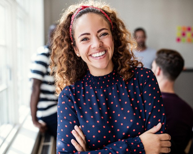 smiling woman with her arms folded