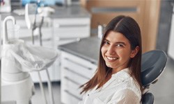 Brunette woman grinning in dental chair
