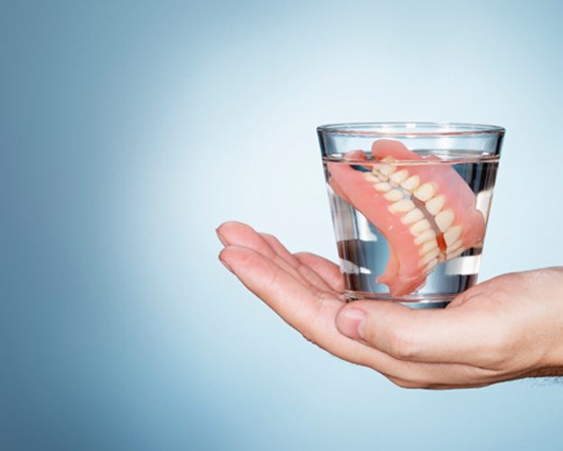 dentures in a glass showing one type of dentures