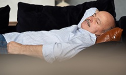 man resting after getting a dental implant in Williamsville