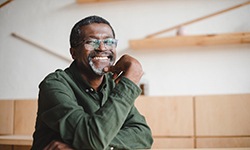 man smiling after new teeth have been attached