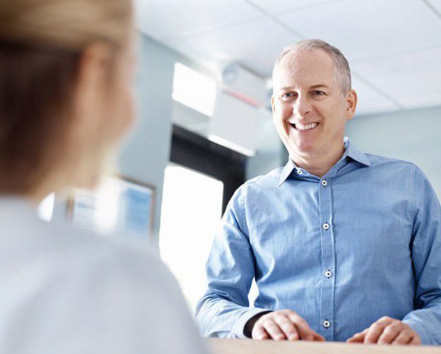 Patient learning about the cost of dental implants in West Seneca