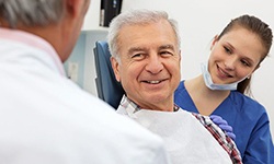 Man smiling while learning about the cost of dental implants in West Seneca