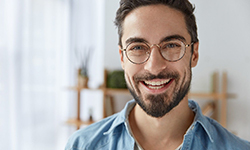 Smiling young man with dental implants