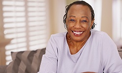Confident woman with dental implants smiling