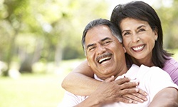 smiling couple hugging outdoors