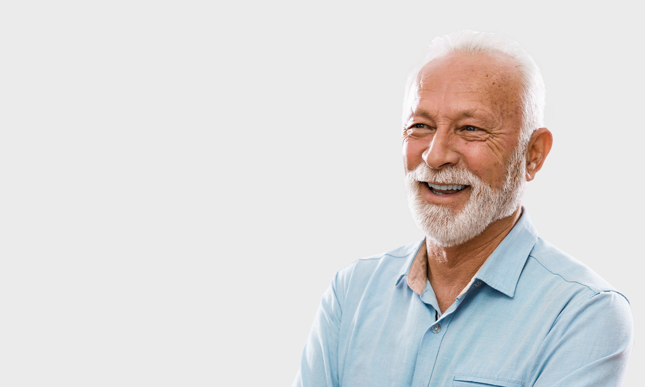 Smiling older man in light blue collared shirt