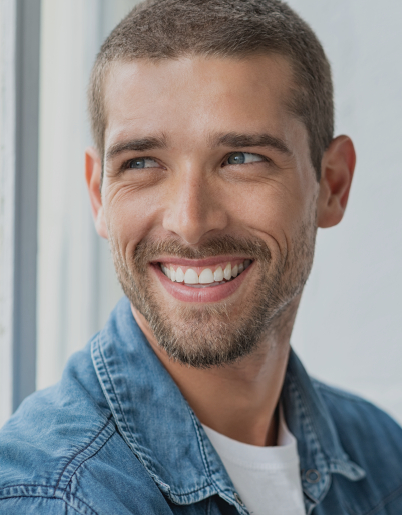 Smiling man in denim shirt