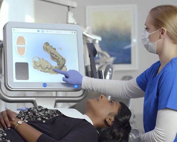 Dentist and dental patient looking at digital bite impressions