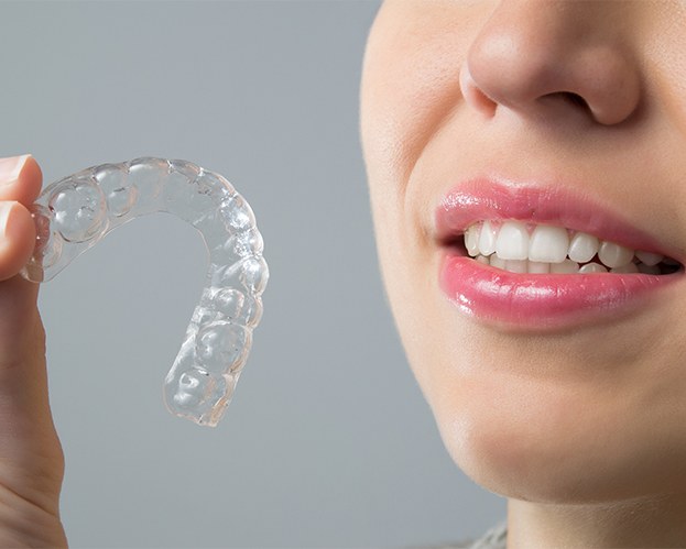 Patient holding Invisalign alignment tray