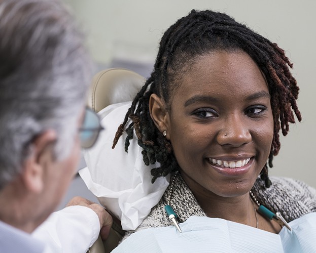 Patient smiling at dentist during preventive dentistry checkup