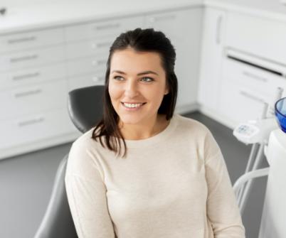 Woman smiling at dentist before receiving dental services in West Seneca