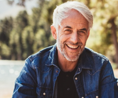 Older man with flawless smile after replacing missing teeth