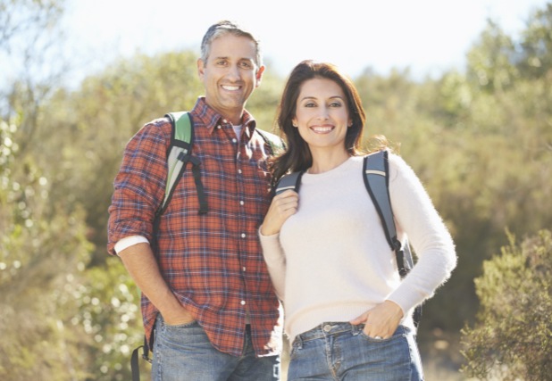 Man and woman on a hike smiling