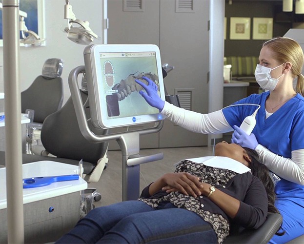 Dental team member capturing iTero intraoral scans of patients' smile