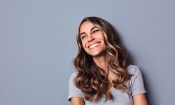 woman smiling after determining the cost of cosmetic dentistry