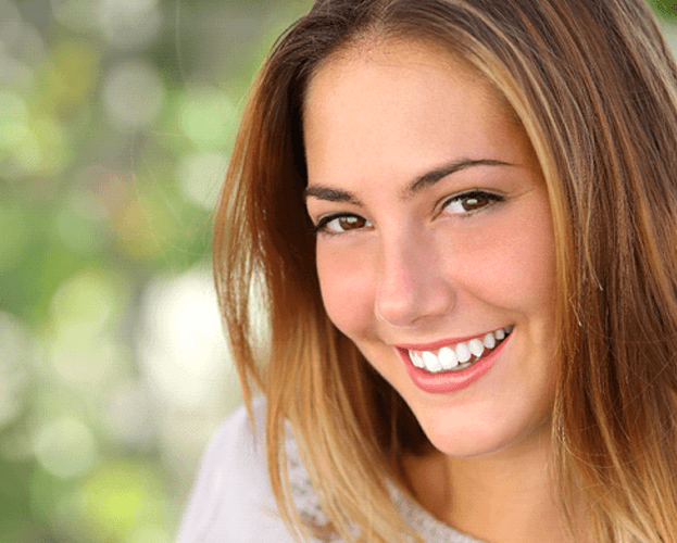 woman smiling in an outdoor setting