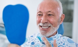 Man looking at smile after in office teeth whitening