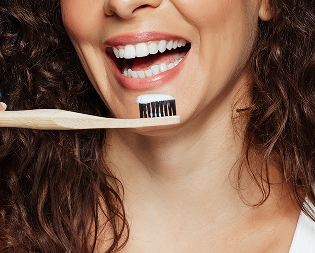 woman with white teeth about to brush