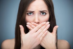 woman shielding breath