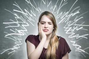 stressed woman with jaw pain 