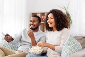 people smiling and eating popcorn