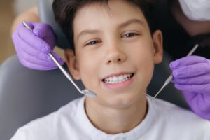 teenage boy smiling in the dentist chair