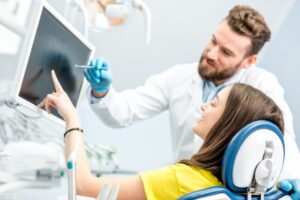patient and doctor looking at an X-ray and talking about treatment
